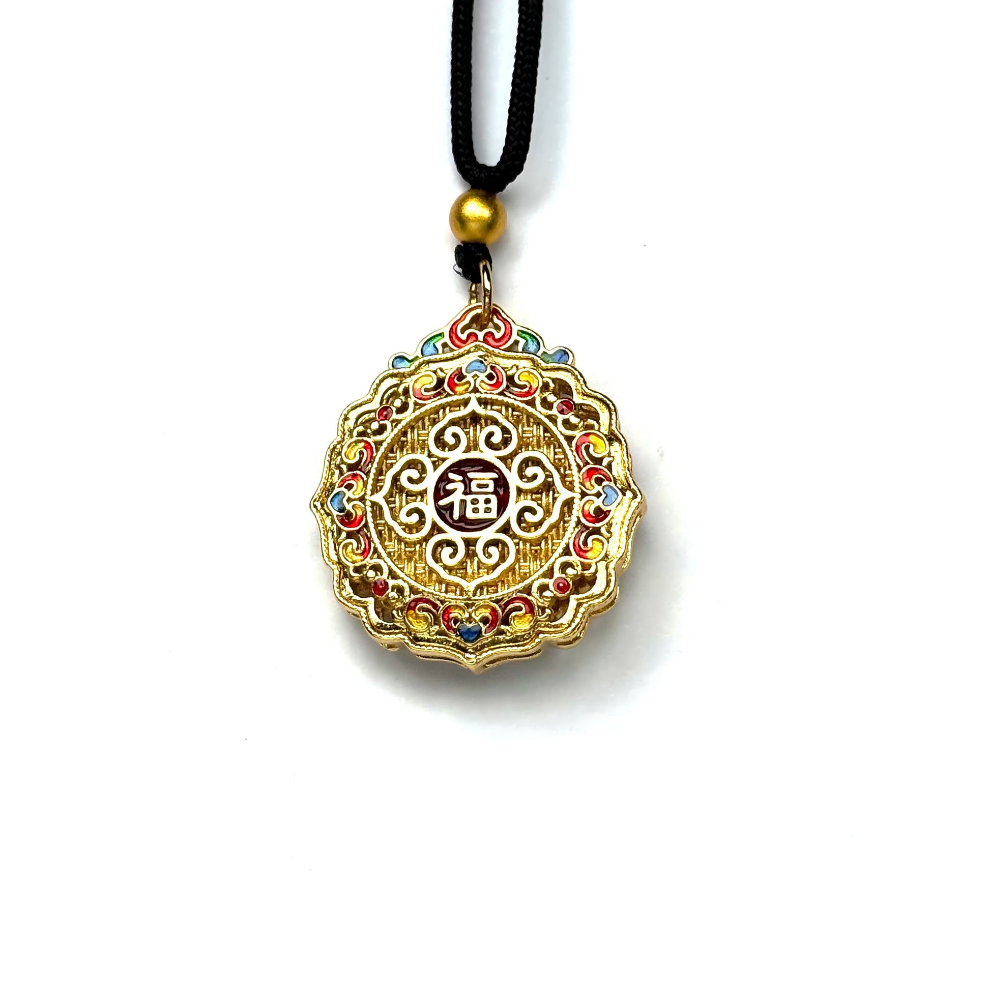The reversible back side of a sand gold fortune charm necklace, showcasing a central red enamel "Fu" blessing character framed by intricate golden filigree and colorful accents.