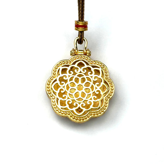 The detailed back view of a sand gold rotating pendant, showcasing a magnificent all-gold embossed Kalachakra wheel mandala pattern on a white background.