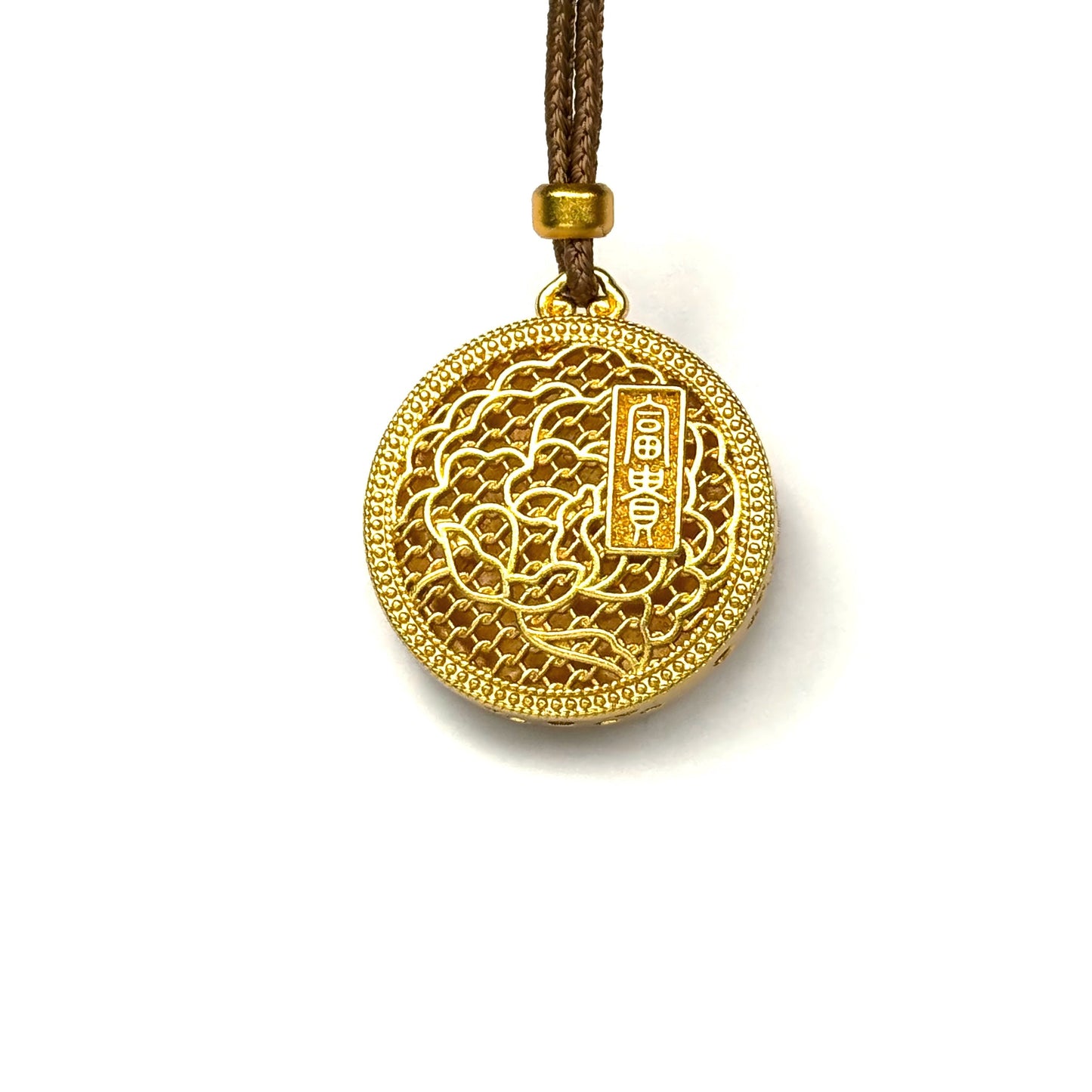 The reversible back side of a sand gold peony necklace, showcasing intricate openwork lattice and a golden plaque with Chinese characters for wealth and prosperity.