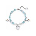 Ice Veil Blue and Clear Beaded Charm Bracelet — overhead view on white