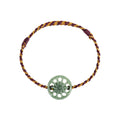 Green Sun Disc Cord Bracelet - overhead view on white