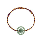 Green Sun Disc Cord Bracelet - overhead view on white