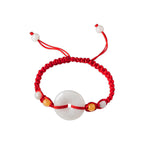 Pale Ring Red Cord Bracelet - overhead view on white