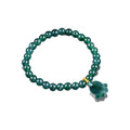 Green Paw Charm Bead Bracelet - overhead view on white