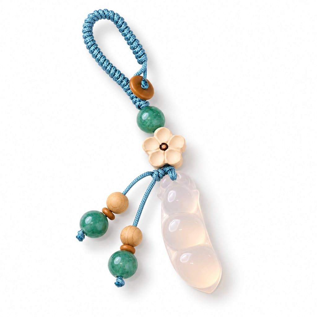 Pale bean pod and flower bag charm — angle