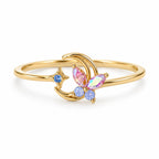 Crescent butterfly gold-tone adjustable ring with pink and blue accents — elevated view