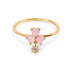 Pink three-petal gold-tone adjustable ring with a clear round drop — elevated view