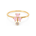 Pink three-petal gold-tone adjustable ring with a clear round drop — hero view