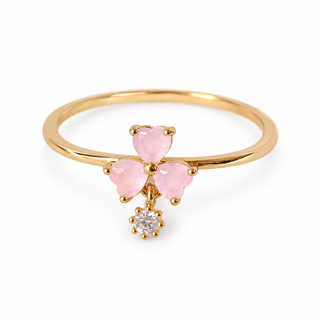 Pink three-petal gold-tone adjustable ring with a clear round drop — left view