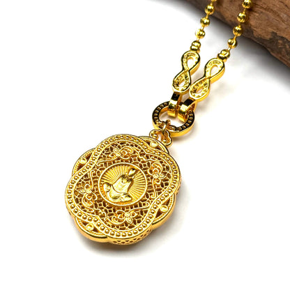The sacred engraved Buddha shrine side of a reversible sand gold talisman charm displayed on rustic wood, showing the protective seated deity.