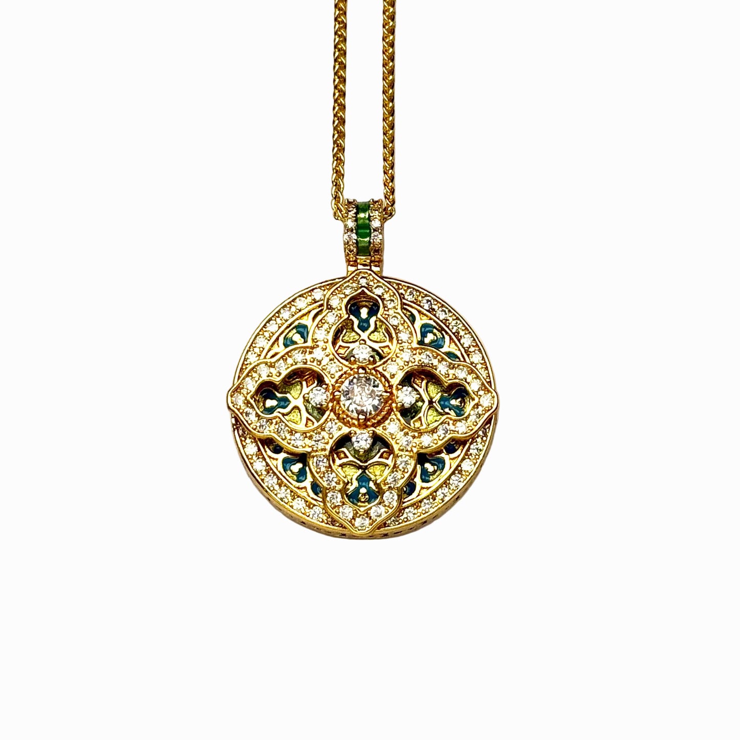 A crisp front view of an authentic sand gold round pendant featuring a pavé diamond crystal cross motif, colorful blue and yellow enamel infills, and a central main rhinestone on a white background.