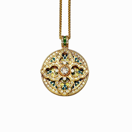 A crisp front view of an authentic sand gold round pendant featuring a pavé diamond crystal cross motif, colorful blue and yellow enamel infills, and a central main rhinestone on a white background.