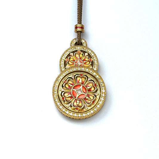 A front view of an authentic sand gold Hulu gourd shape pendant featuring rich orange enamel lotus mandala and a brilliant double-row rhinestone border on a white background.