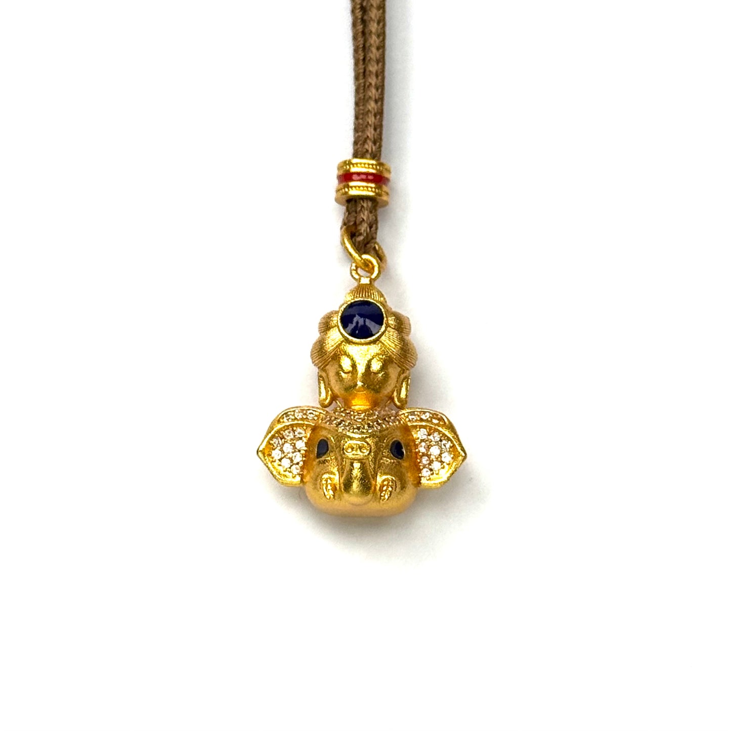 A front view of an authentic sand gold Lord Ganesha elephant pendant featuring rhinestone ears and a blue gemstone crown on a white background.