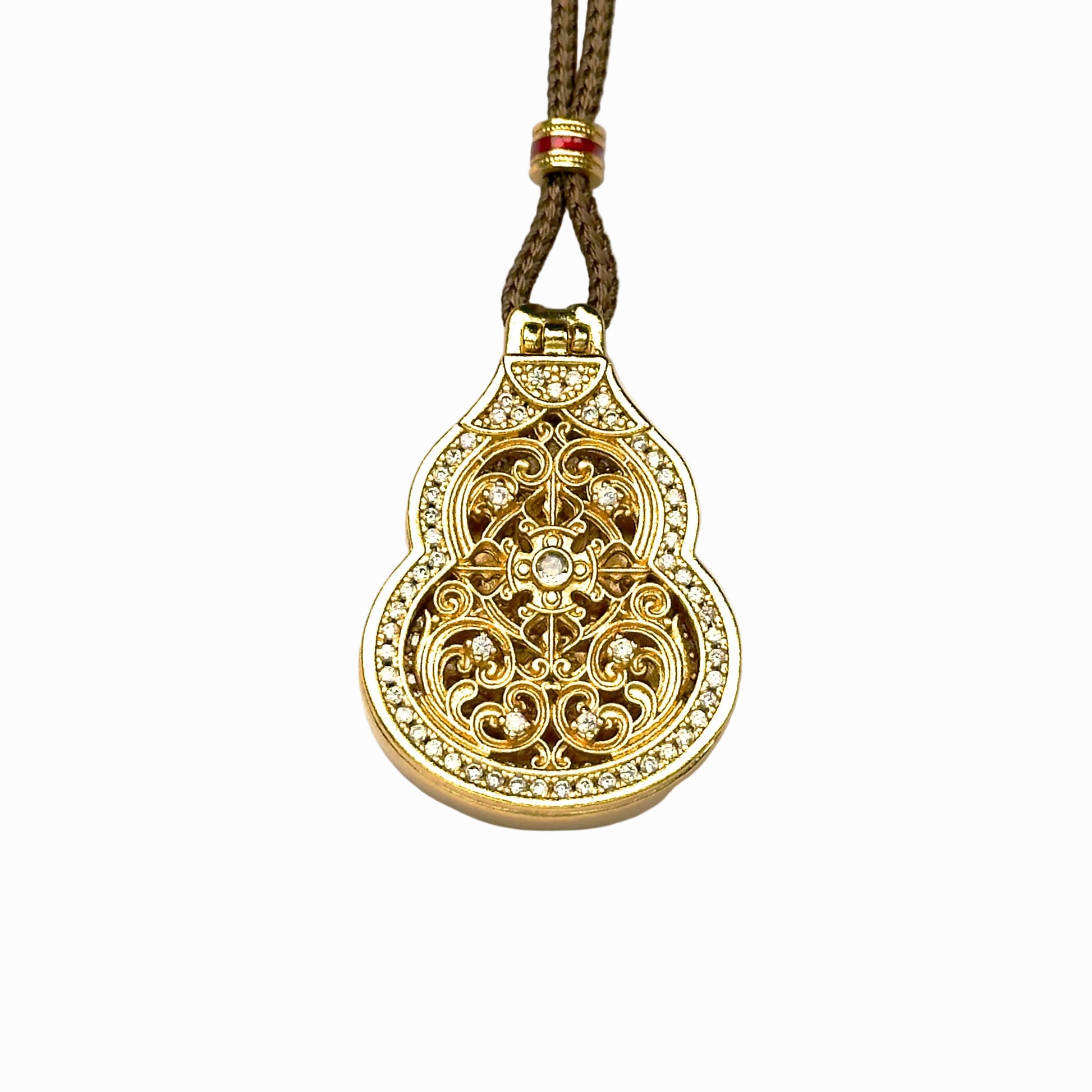 A front closed view of an authentic sand gold Hulu gourd locket pendant featuring an intricate openwork lattice cover and a brilliant micro-pave rhinestone border on a white background.