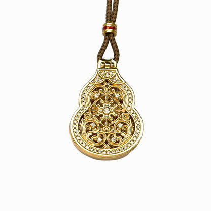 A front closed view of an authentic sand gold Hulu gourd locket pendant featuring an intricate openwork lattice cover and a brilliant micro-pave rhinestone border on a white background.