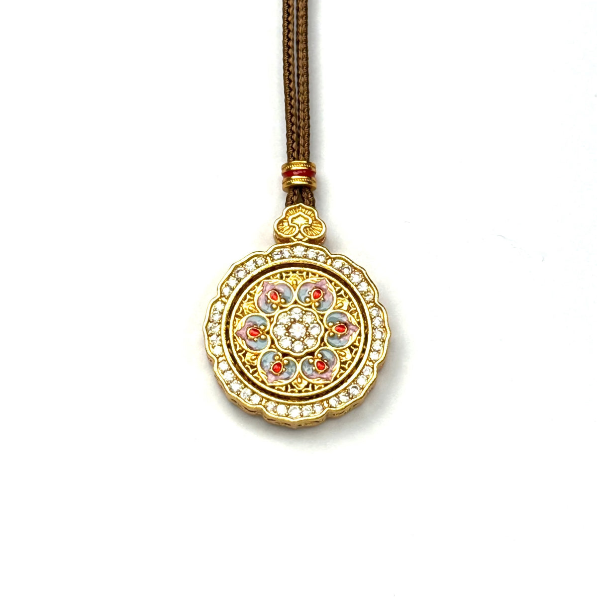 A front view of a sand gold spinning lotus pendant featuring pastel pink and blue enamel detailing with a sparkling rhinestone border on a white background.