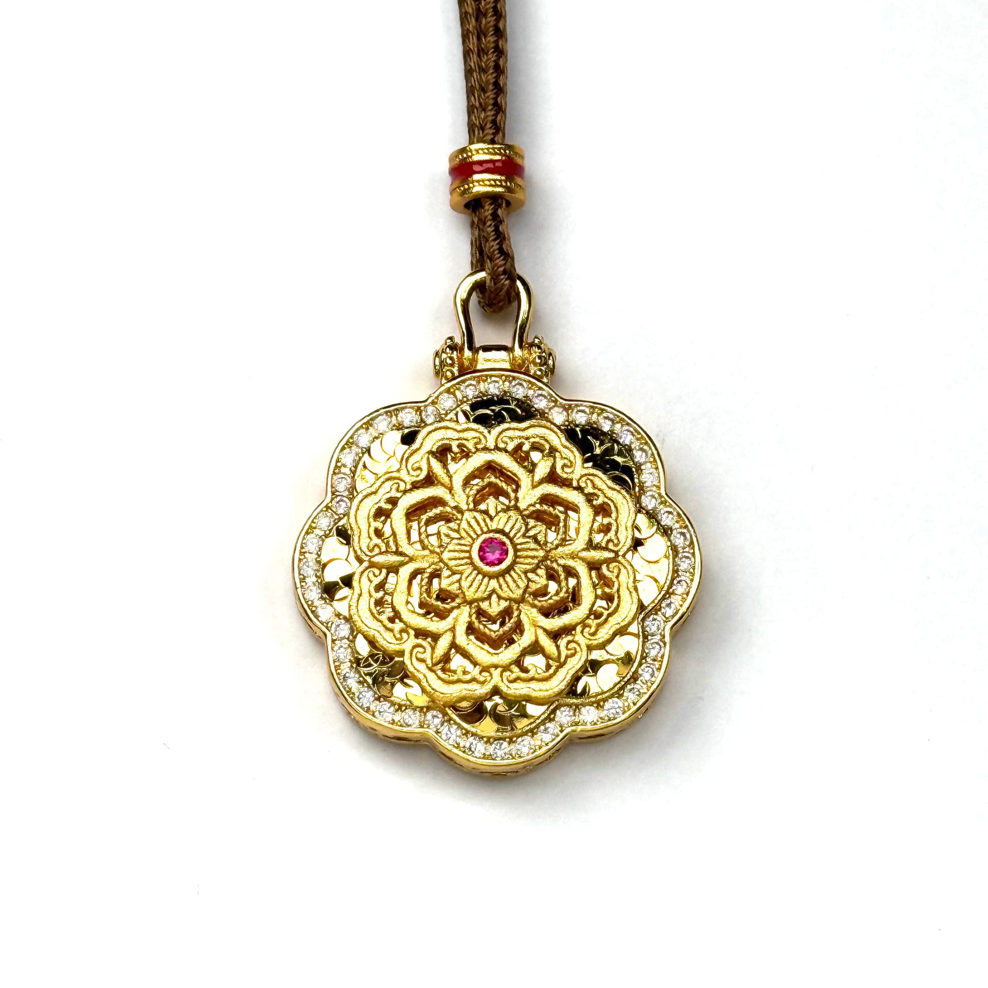 A front view of a sand gold spinning mandala pendant featuring an inner ring of marquise-cut faux rubies and a brilliant double-row rhinestone border on a white background.