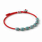 Seven Oval Bead Red Cord Bracelet - angled view on white