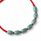 Seven Oval Bead Red Cord Bracelet - centerpiece detail on white