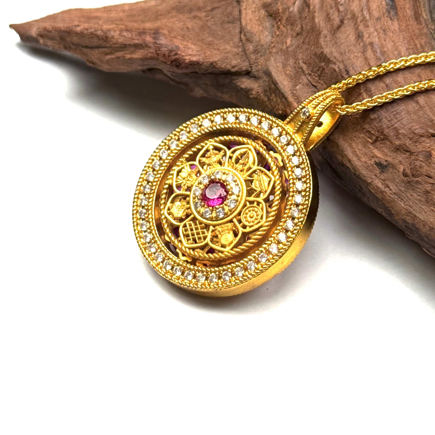 Top-down macro shot of a traditional sand gold spinning wheel necklace on driftwood, perfect for stress relief and mindfulness.