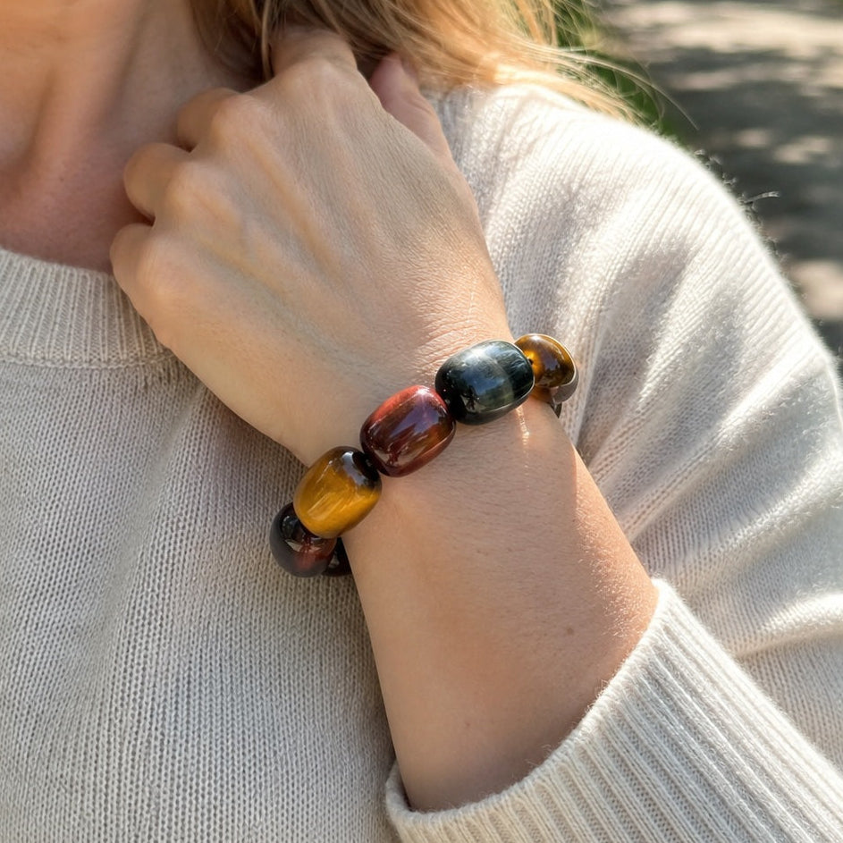 Close-up of a tricolor tiger’s eye barrel bead bracelet worn on the wrist