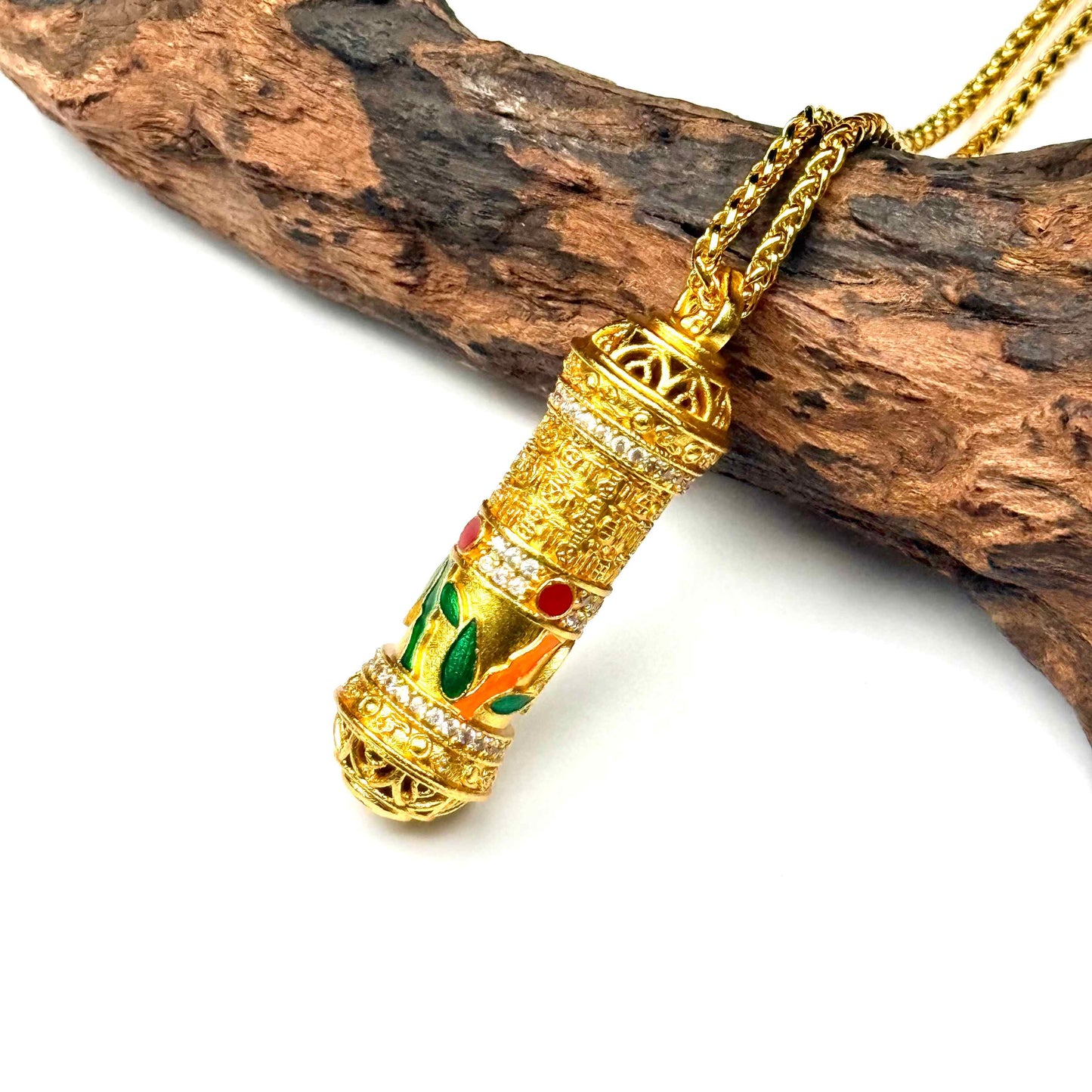 Macro horizontal view of a heavy sand gold fidget spinner prayer wheel necklace on wood, capturing the intricate mantra text and premium wheat chain.