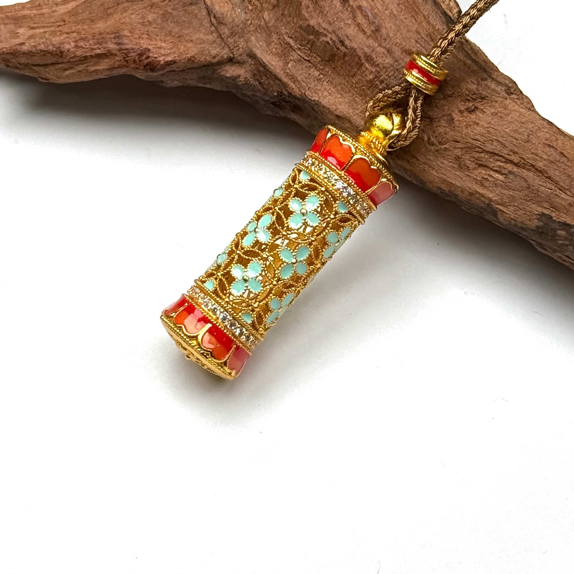 Top-down macro shot of a luxurious sand gold folding fan pendant with dazzling crystal accents and a gold water-wave chain displayed elegantly on wood.